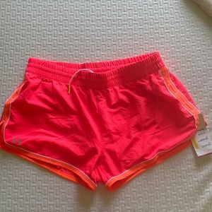 NWT bright pink and orange under Armour running shorts